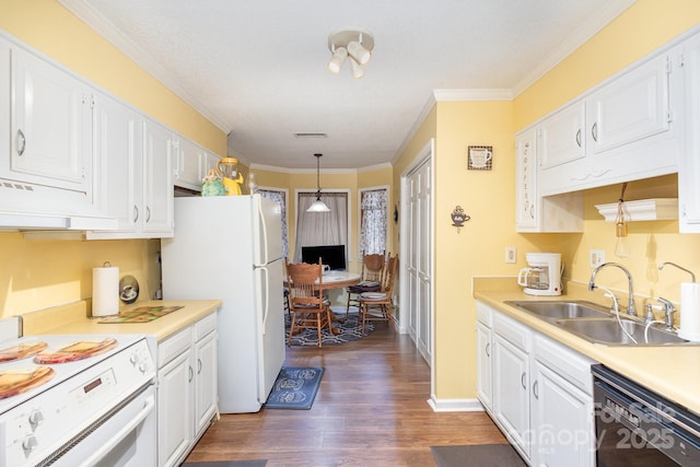 kitchen with light countertops, white appliances, a sink, and white cabinetry