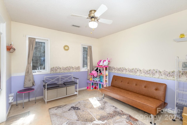 interior space featuring carpet floors, ceiling fan, visible vents, and baseboards