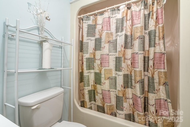 bathroom featuring toilet and shower / bath combination with curtain