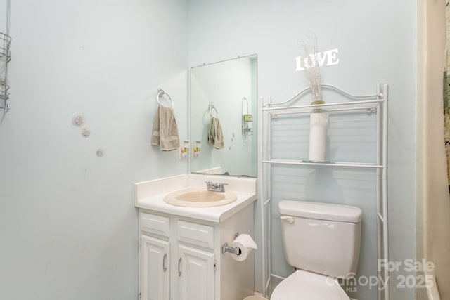 bathroom featuring vanity and toilet