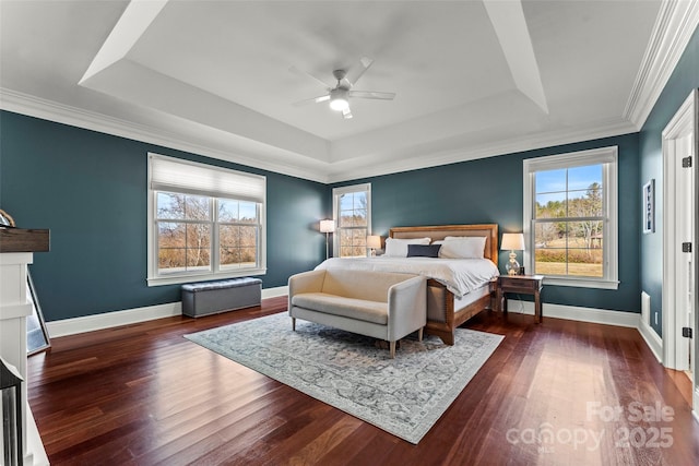 bedroom featuring dark wood-style floors, baseboards, and a raised ceiling