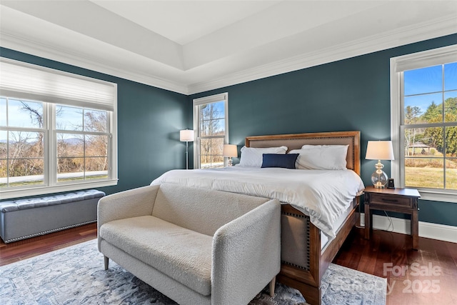 bedroom with baseboards, dark wood finished floors, and ornamental molding