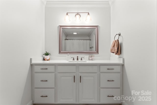 full bathroom with ornamental molding and vanity