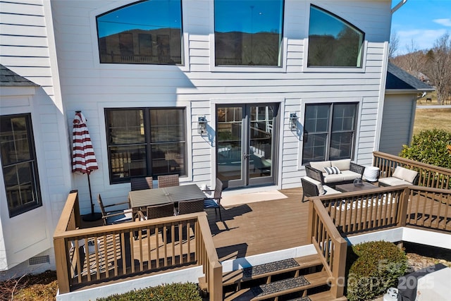 wooden terrace with an outdoor living space