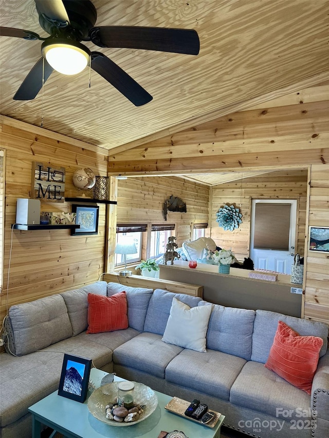 living area with lofted ceiling, wood ceiling, and wooden walls