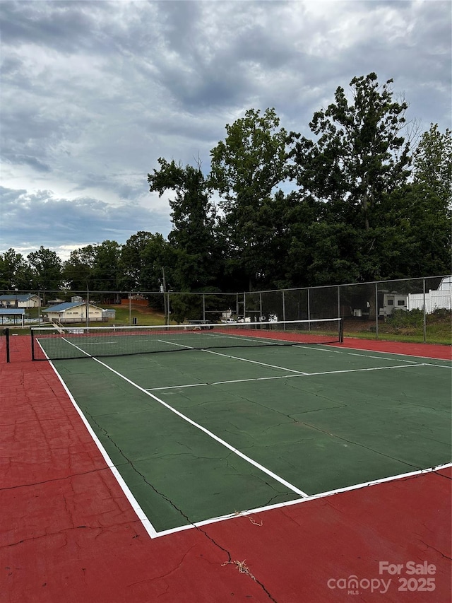 view of sport court featuring fence