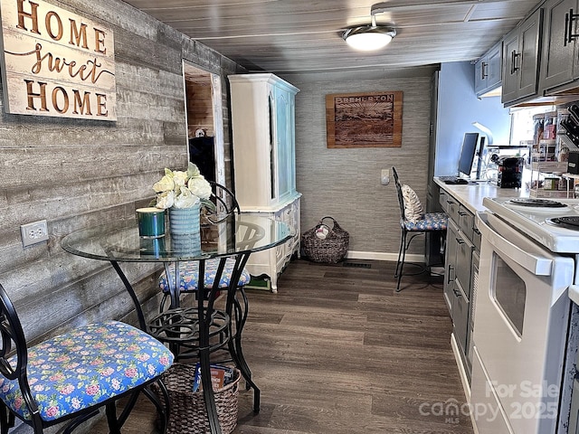 kitchen with dark wood-type flooring, white range with electric stovetop, wood ceiling, and baseboards