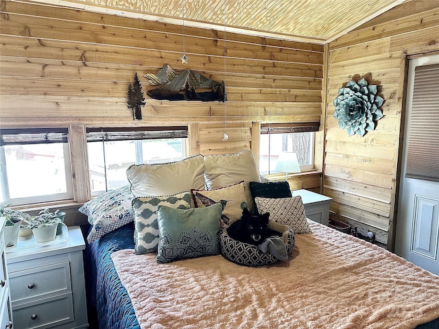 bedroom with vaulted ceiling and wooden walls