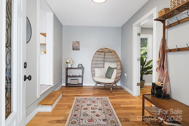 sitting room with light wood-type flooring and baseboards