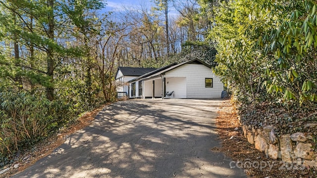 view of side of home with aphalt driveway