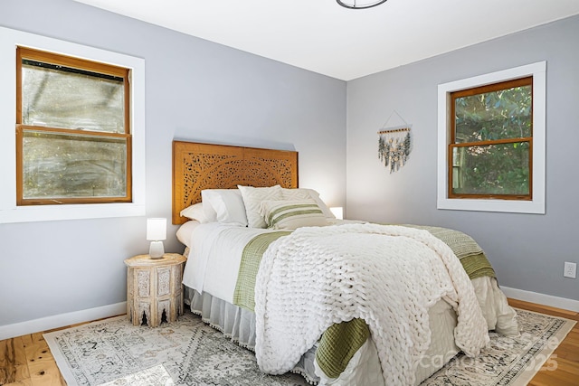 bedroom featuring baseboards and wood finished floors