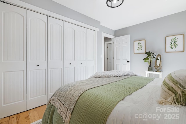 bedroom with a closet and wood finished floors