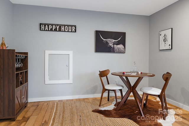 dining space with light wood-style floors and baseboards