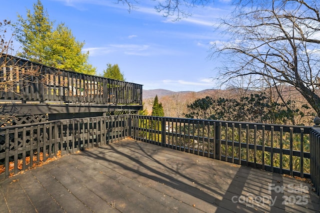 wooden deck with a mountain view