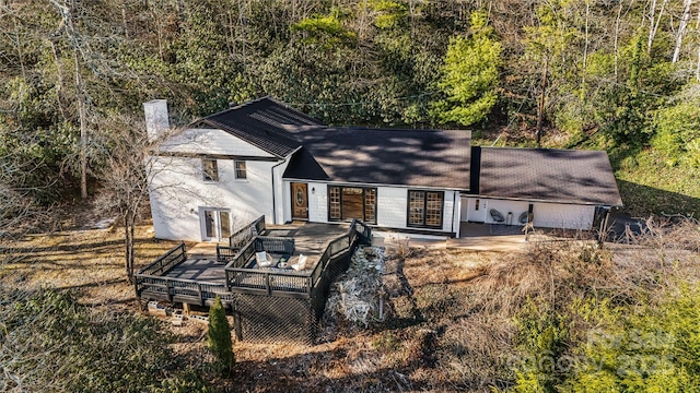 view of front of home with french doors, a chimney, and a wooden deck