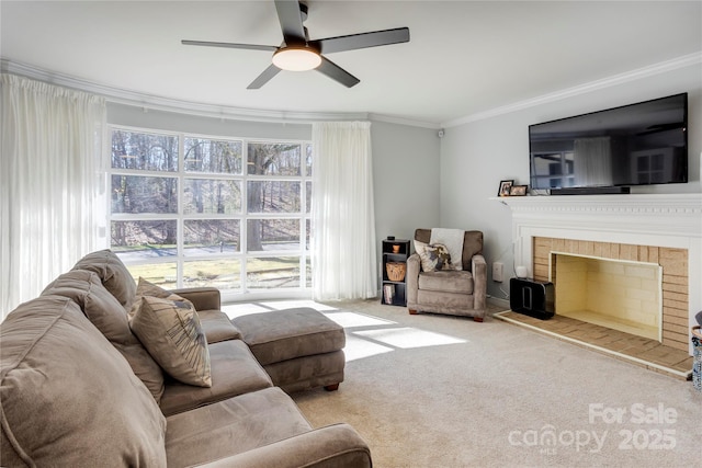 living area featuring light carpet, ornamental molding, a tile fireplace, and a ceiling fan