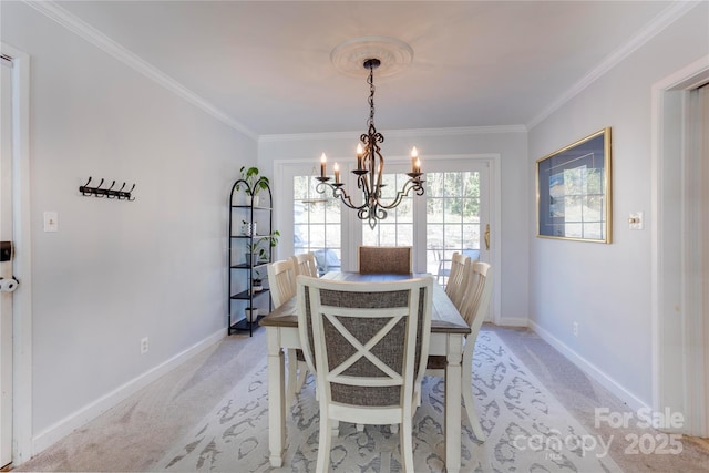 dining space with ornamental molding, light colored carpet, and baseboards