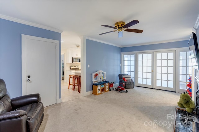 rec room with light carpet, ceiling fan, and ornamental molding