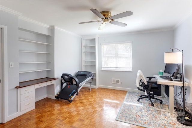 office area featuring ceiling fan, built in shelves, baseboards, and crown molding