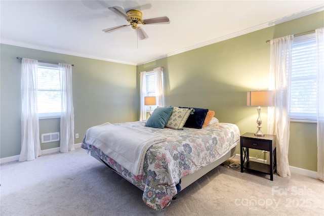 bedroom featuring baseboards, ornamental molding, visible vents, and light colored carpet