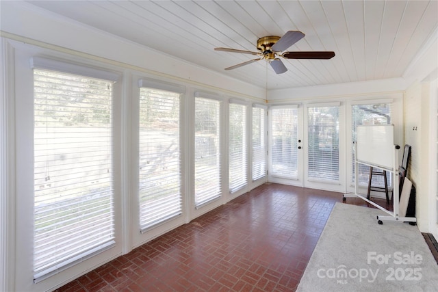 unfurnished sunroom featuring ceiling fan and wood ceiling