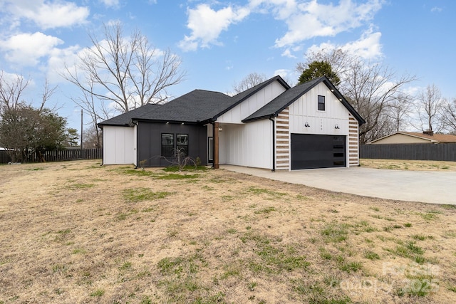 modern farmhouse style home featuring an attached garage, a shingled roof, fence, driveway, and board and batten siding