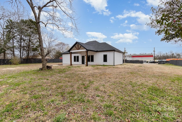 view of front of house with a front yard and a fenced backyard