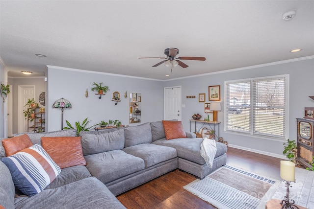 living area featuring ornamental molding, dark wood-style flooring, baseboards, and a ceiling fan