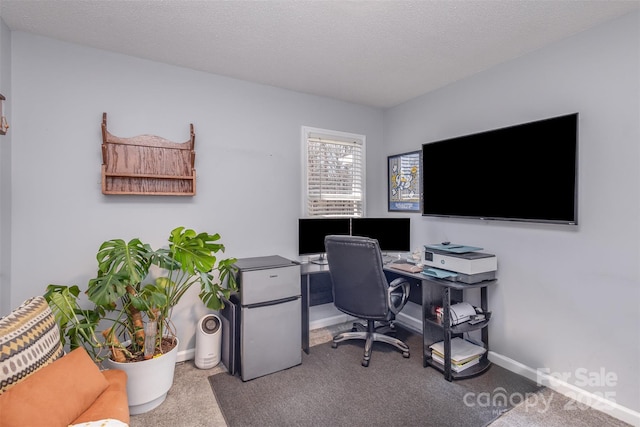 office area featuring carpet floors, baseboards, and a textured ceiling