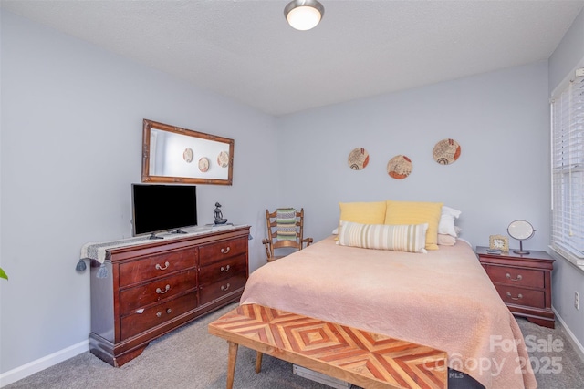 bedroom with baseboards and light colored carpet