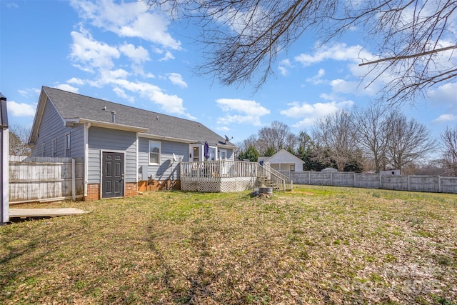 view of yard with a fenced backyard and a wooden deck