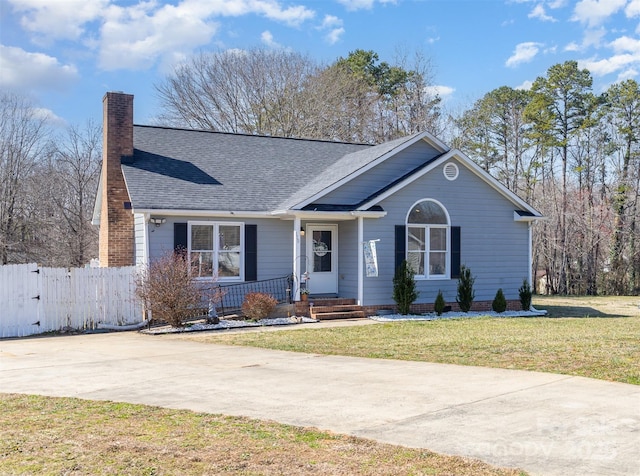 single story home with roof with shingles, a chimney, a front yard, and fence