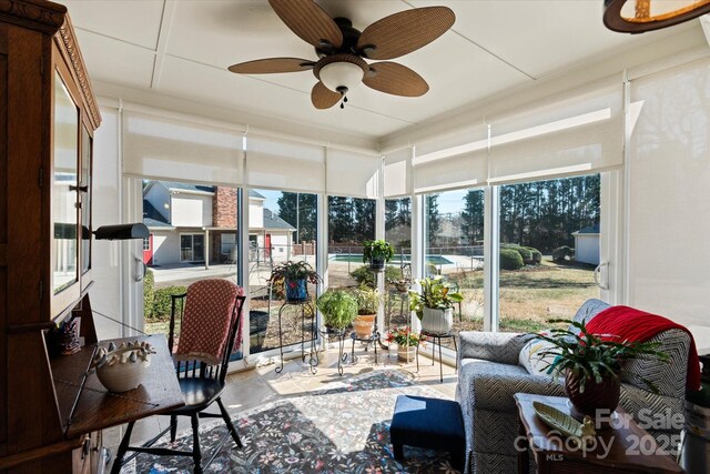 sunroom with plenty of natural light and a ceiling fan