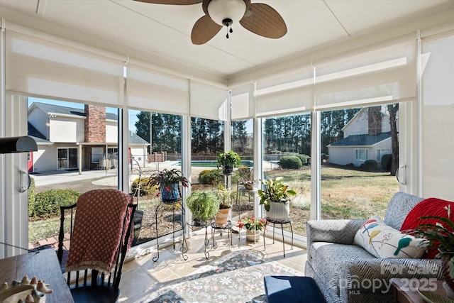 sunroom with a wealth of natural light and a ceiling fan