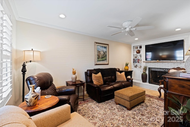 living room with a fireplace, wood finished floors, a ceiling fan, built in features, and crown molding