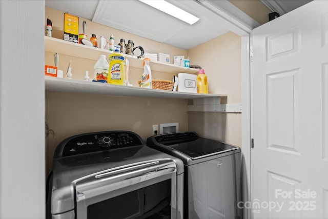 clothes washing area with laundry area and washer and clothes dryer