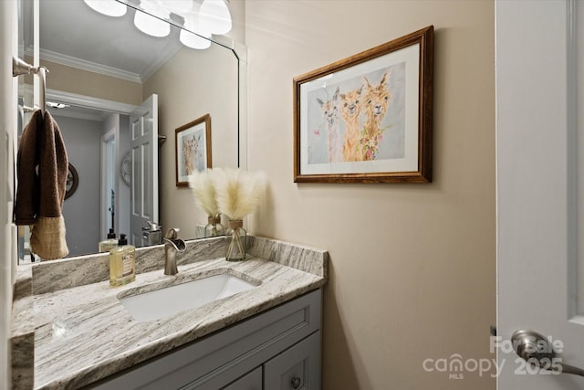 bathroom with ornamental molding and vanity