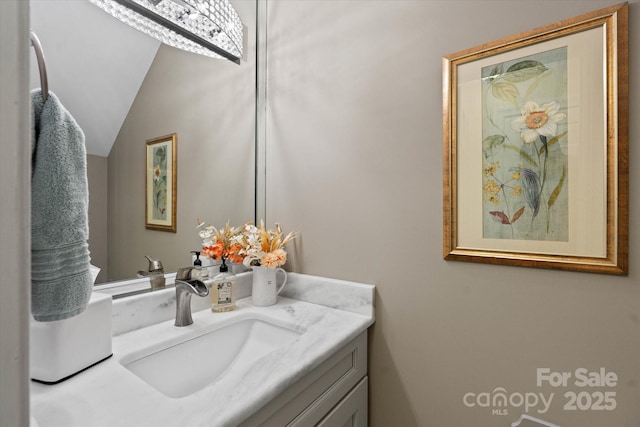 bathroom featuring lofted ceiling and vanity