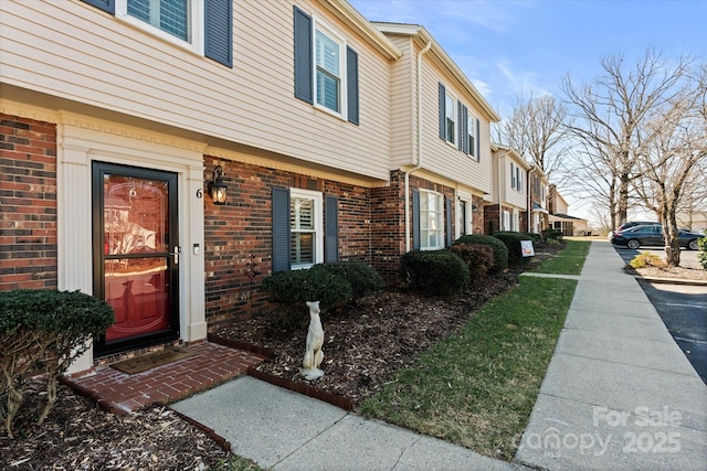 view of exterior entry with brick siding