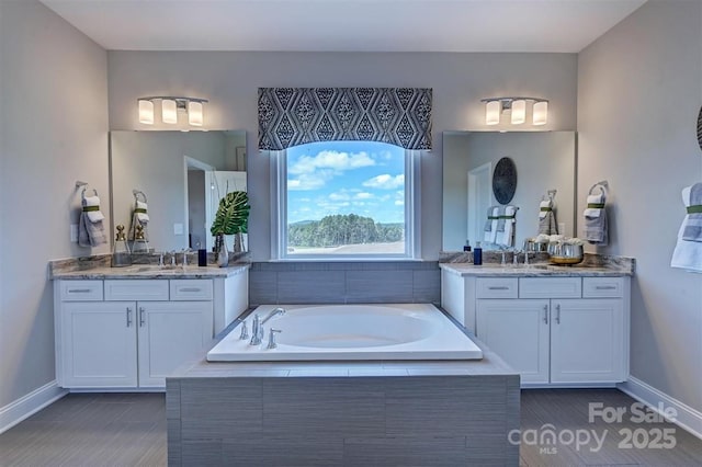 173 Glenn Dr, Mooresville, NC 28115 - full bath with baseboards, two vanities, and a bath