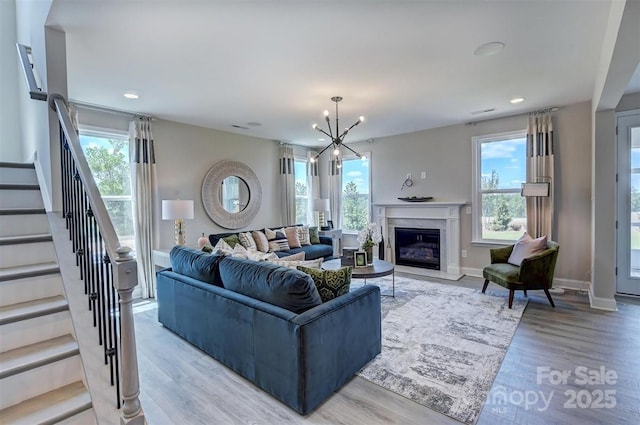 173 Glenn Dr, Mooresville, NC 28115 - living area with light wood finished floors, a chandelier, stairs, recessed lighting, and baseboards