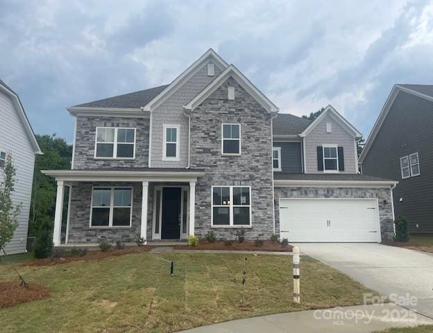 173 Glenn Dr, Mooresville, NC 28115 - craftsman-style house with stone siding, concrete driveway, a front yard, and an attached garage