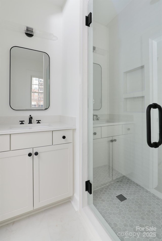 bathroom with a stall shower and vanity