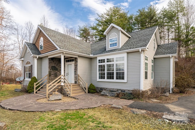 cape cod home with roof with shingles and crawl space