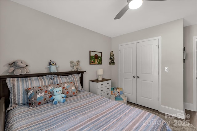 bedroom featuring ceiling fan, a closet, and baseboards