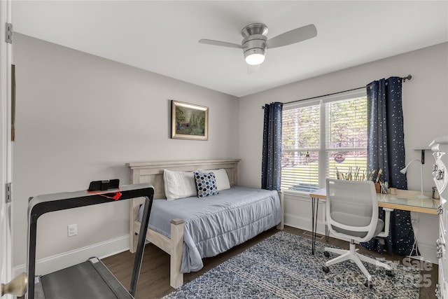 bedroom with ceiling fan, dark wood-type flooring, and baseboards