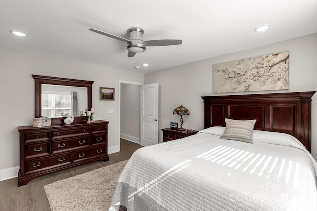 bedroom with recessed lighting, dark wood-style flooring, and baseboards