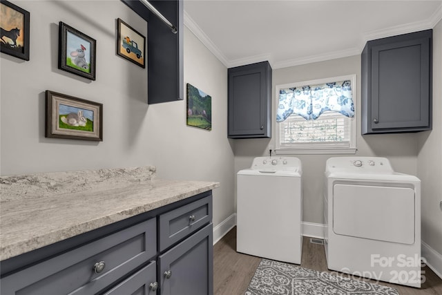 laundry area with crown molding, dark wood finished floors, cabinet space, independent washer and dryer, and baseboards