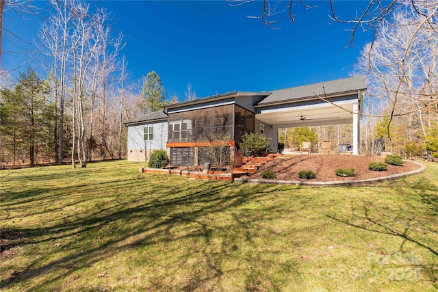 rear view of property featuring a lawn, a patio, a sunroom, ceiling fan, and stairs