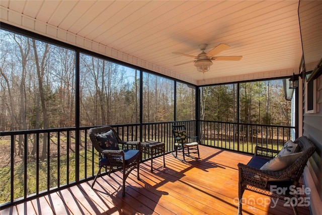 sunroom / solarium featuring plenty of natural light and a ceiling fan